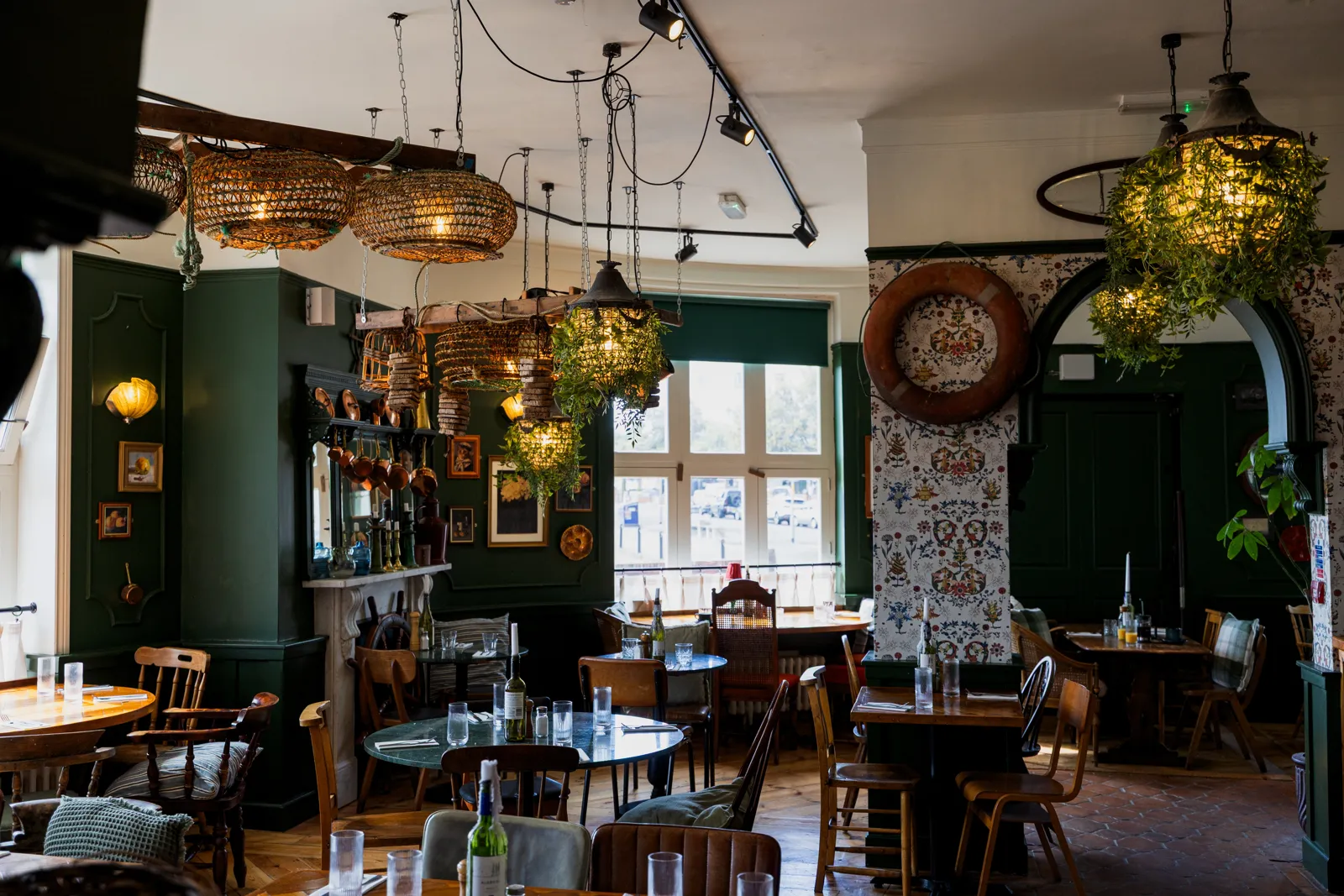 The other side of the green dining room, with chandeliers and set tables