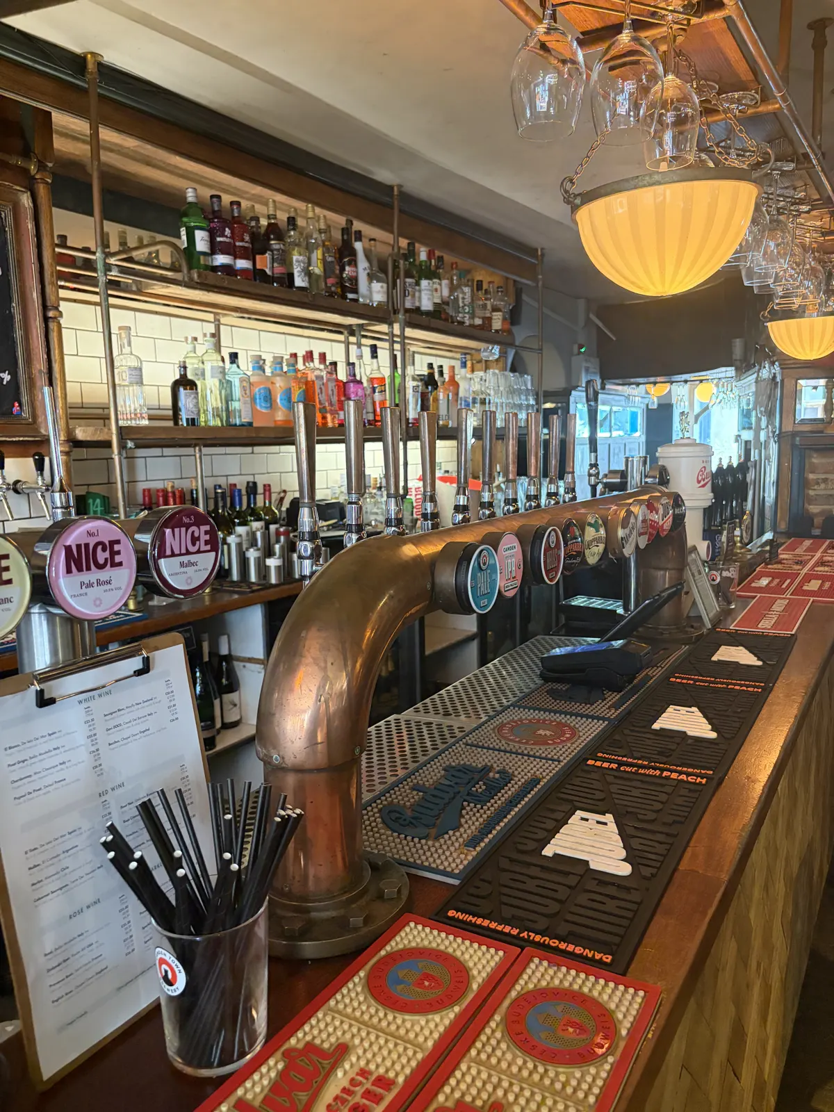 The bar at The Pullman with taps and shelves of spirits