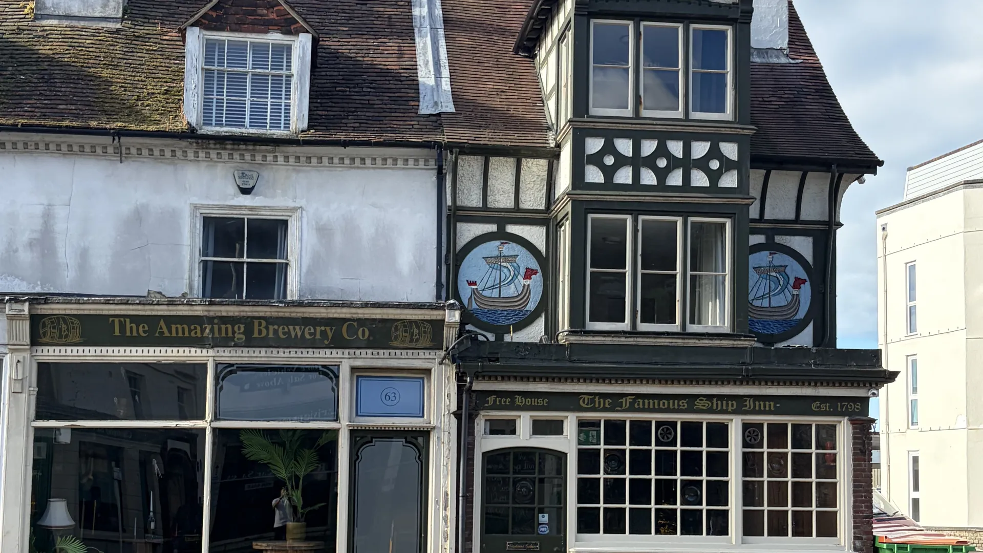 The Ship Inn’s mock-Tudor frontage on Sandgate High Street under a blue sky
